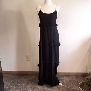 Long black dress with tiny ruffles around the seams.